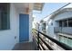 Balcony view with black metal railing, blue door and exterior of modern townhouses at 5008 S Macdill Ave # 10, Tampa, FL 33611