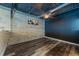Bedroom featuring exposed ceilings, wood floors, and a modern accent wall at 5008 S Macdill Ave # 10, Tampa, FL 33611