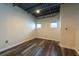 Loft bedroom featuring exposed ceiling, wood floors, and a minimalist aesthetic at 5008 S Macdill Ave # 10, Tampa, FL 33611