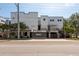Modern building with garages on the bottom floor and palm trees in front at 5008 S Macdill Ave # 10, Tampa, FL 33611