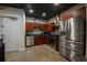 Sleek kitchen with stainless steel appliances, dark cabinets, and a modern backsplash at 5008 S Macdill Ave # 10, Tampa, FL 33611