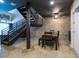 Kitchen and dining area featuring modern black staircase, concrete floors, and stainless appliances at 5008 S Macdill Ave # 10, Tampa, FL 33611