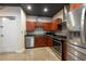 Contemporary kitchen featuring stainless steel appliances, mosaic backsplash, and granite countertops at 5008 S Macdill Ave # 10, Tampa, FL 33611