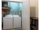 Functional laundry area features modern washer and dryer with updated water heater at 5008 S Macdill Ave # 10, Tampa, FL 33611