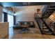 Modern living room with concrete walls, comfortable sofa, and sleek metal staircase at 5008 S Macdill Ave # 10, Tampa, FL 33611