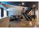 Modern living room with a comfortable leather sofa, concrete floors, and a staircase at 5008 S Macdill Ave # 10, Tampa, FL 33611