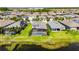 Aerial view of pool, landscaping, and nearby pond at 5814 Silver Sun Dr, Apollo Beach, FL 33572