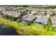 Aerial view of pool, landscaping, and nearby pond at 5814 Silver Sun Dr, Apollo Beach, FL 33572