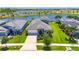 Beautiful home with well-manicured lawn and landscaping next to a scenic lake and lush greenery at 5814 Silver Sun Dr, Apollo Beach, FL 33572