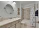 Bathroom with a vanity, oval mirror, and tub-shower combination behind a nautical-themed shower curtain at 5814 Silver Sun Dr, Apollo Beach, FL 33572