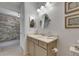 Bathroom featuring neutral colored walls, a vanity, framed artwork, and views into another room at 5814 Silver Sun Dr, Apollo Beach, FL 33572