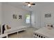 Bedroom with two twin beds, white walls and trim, double door closet and ceiling fan at 5814 Silver Sun Dr, Apollo Beach, FL 33572
