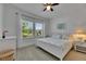 Bedroom featuring a large window letting in tons of natural light, white trim, carpet, and a ceiling fan at 5814 Silver Sun Dr, Apollo Beach, FL 33572