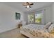 Sun-filled bedroom featuring two large windows, light colored carpet, white trim and a ceiling fan at 5814 Silver Sun Dr, Apollo Beach, FL 33572