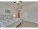 Carpeted bedroom featuring an ensuite bathroom, closet, coastal accents, and plenty of natural light at 5814 Silver Sun Dr, Apollo Beach, FL 33572