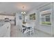 Open floor plan reveals a dining room with white wood flooring and an adjacent kitchen at 5814 Silver Sun Dr, Apollo Beach, FL 33572