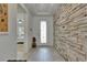 Elegant entryway with a decorative front door and textured stone accent wall at 5814 Silver Sun Dr, Apollo Beach, FL 33572