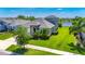 Inviting exterior view of a home with a well-kept lawn and a view of a tranquil lake at 5814 Silver Sun Dr, Apollo Beach, FL 33572