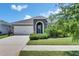 Charming home featuring a stone accented entry, two-car garage, and lush landscaping at 5814 Silver Sun Dr, Apollo Beach, FL 33572