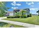 Two-story Gathering home with a two-car garage and gorgeous green landscaping at 5814 Silver Sun Dr, Apollo Beach, FL 33572