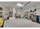 Spacious two car garage with epoxy flooring, utility sink, shelves and exterior door at 5814 Silver Sun Dr, Apollo Beach, FL 33572