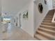 Entry hallway with staircase to the right, open view into the kitchen and living room at 5814 Silver Sun Dr, Apollo Beach, FL 33572