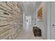 Inviting hallway featuring stylish stone accent wall at 5814 Silver Sun Dr, Apollo Beach, FL 33572