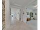 Spacious hallway with light wood-look floors leading to rooms with neutral paint and decor at 5814 Silver Sun Dr, Apollo Beach, FL 33572