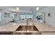 Kitchen island with stone countertop overlooking the dining room, living area, and water view at 5814 Silver Sun Dr, Apollo Beach, FL 33572