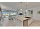 Beautiful kitchen island with stainless steel dishwasher overlooking the living area and outdoor views at 5814 Silver Sun Dr, Apollo Beach, FL 33572