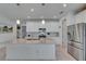 Modern kitchen showcasing an island, granite countertops, stainless steel appliances and lots of natural light at 5814 Silver Sun Dr, Apollo Beach, FL 33572