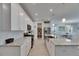 Modern kitchen featuring white cabinetry, granite countertops, stainless steel appliances, and walk-in pantry at 5814 Silver Sun Dr, Apollo Beach, FL 33572