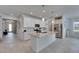 Well-lit kitchen with stainless steel appliances, granite countertops and large center island at 5814 Silver Sun Dr, Apollo Beach, FL 33572