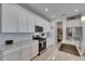 Modern kitchen showcasing white cabinets, granite countertops, and stainless steel appliances at 5814 Silver Sun Dr, Apollo Beach, FL 33572