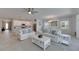 Bright living room features an open floor plan, white sofas with blue pillows and stylish decor at 5814 Silver Sun Dr, Apollo Beach, FL 33572