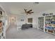 Bright, spacious living room with large ceiling fan and built-in bookshelves at 5814 Silver Sun Dr, Apollo Beach, FL 33572
