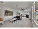 Living area with a sofa, desk, shelving, and lots of natural light at 5814 Silver Sun Dr, Apollo Beach, FL 33572