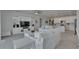 Spacious living room that blends into the kitchen featuring a white sectional and entertainment center at 5814 Silver Sun Dr, Apollo Beach, FL 33572