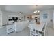 Open-concept living room with white furniture, dining table, and kitchen with plenty of natural light at 5814 Silver Sun Dr, Apollo Beach, FL 33572