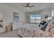 Cozy bedroom with soft carpet, a ceiling fan, and ample natural light at 5814 Silver Sun Dr, Apollo Beach, FL 33572