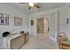 Bright office with white walls, ceiling fan, wood-look floors, and double doors to the rest of the home at 5814 Silver Sun Dr, Apollo Beach, FL 33572