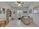 Sunlit home office with light wood floors, bright white walls, coastal decor, and ample storage space at 5814 Silver Sun Dr, Apollo Beach, FL 33572