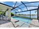Screened in pool, spa, and patio overlooking a lake at 5814 Silver Sun Dr, Apollo Beach, FL 33572
