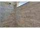 Tiled shower stall features modern fixtures and neutral gray tiled walls at 5814 Silver Sun Dr, Apollo Beach, FL 33572