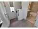 Carpeted stairway featuring white walls and an adjacent bathroom at 5814 Silver Sun Dr, Apollo Beach, FL 33572