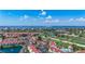High aerial showcasing the condo community with golf course, landscaping, and waterfront views at 6059 Bahia Del Mar Blvd # 235, St Petersburg, FL 33715