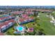 An aerial view of condos, a pool, golf course, and landscaping showcasing the beautiful community at 6059 Bahia Del Mar Blvd # 235, St Petersburg, FL 33715