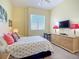 Cozy bedroom with soft lighting, a comfortable bed, and a dresser with TV, perfect for relaxation at 6059 Bahia Del Mar Blvd # 235, St Petersburg, FL 33715