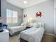 Charming bedroom with two twin beds, cute crab decor, and abundant natural light at 6059 Bahia Del Mar Blvd # 235, St Petersburg, FL 33715