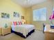 Inviting bedroom with a calming color scheme, comfortable bed, and ample natural light from the window at 6059 Bahia Del Mar Blvd # 235, St Petersburg, FL 33715